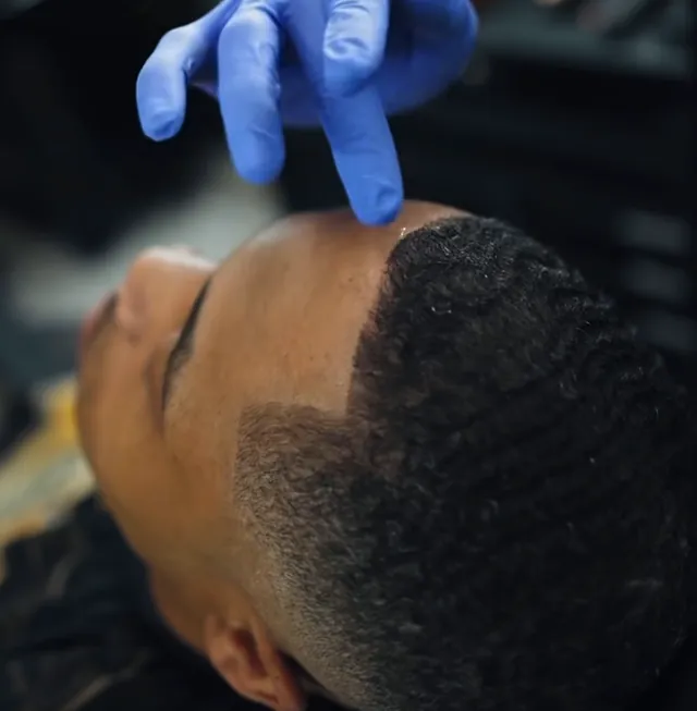 A fresh fade being checked by hand at Pharaohs